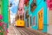 Lisbon,,Portugal,-,Yellow,Tram,On,A,Street,With,Colorful
